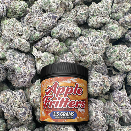 Container of Apple Fritters candy on a bed of green flower